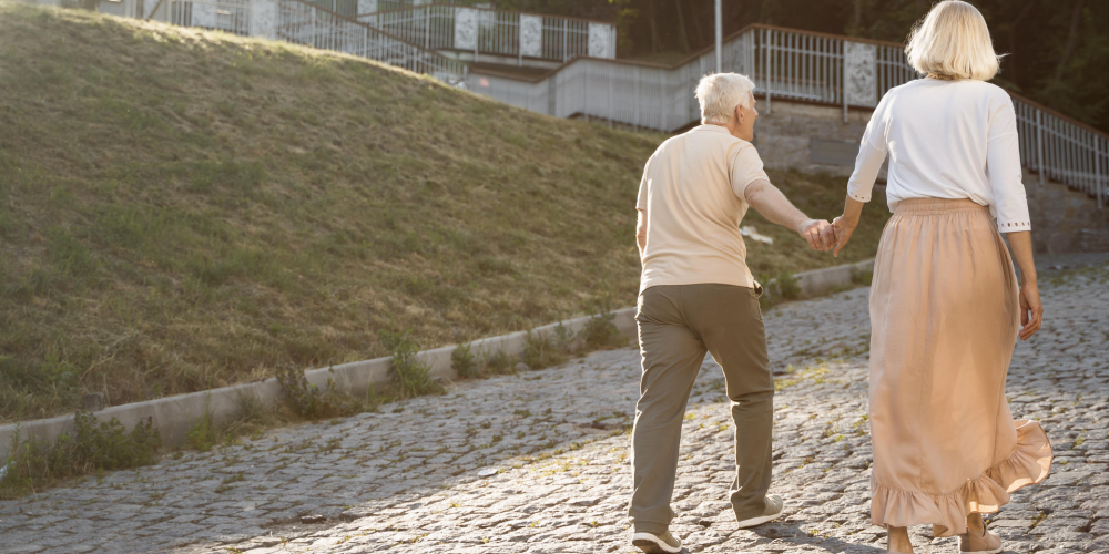 back-view-senior-couple-holding-hands-while-out-city